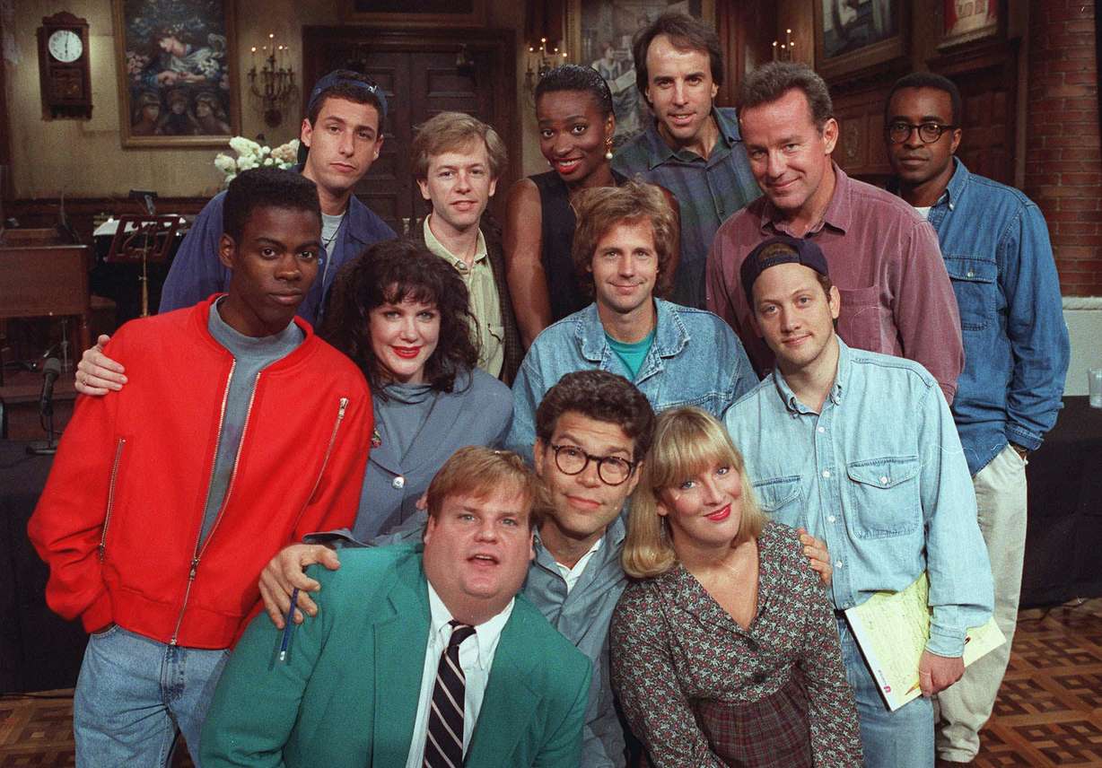 The cast of NBC's "Saturday Night Live" pose on the show's set in New York, Sept. 22, 1992. From left, front row, are: Chris Farley, Al Franken and Melanie Hutsell. In middle row, from left, are: Chris Rock, Julia Sweeney, Dana Carvey and Rob Schneider. In back row, from left, are: Adam Sandler, David Spade, Ellen Cleghorne, Kevin Nealon, Phil Hartman and Tim Meadows. (Justin Sutcliffe/AP Photo)