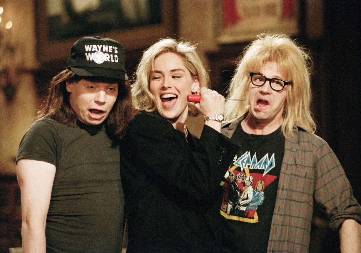 Sharon Stone holds an ice pick up to Dana Carvey's, as Garth, face, as Mike Myers, as Wayne, stands by during taping of a promotional spot for NBC's Saturday Night Live in New York at Thursday's rehearsal April 9, 1992. Stone, who stars opposite Michael Douglas in "Basic Instinct" will host "SNL" joined by the team of Wayne & Garth of "Wayne's World". (Richard Drew/AP Photo)