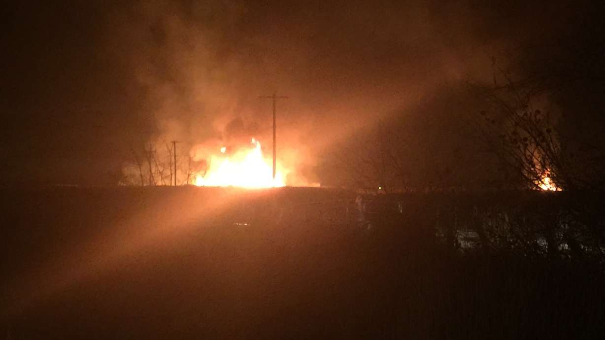 Small grass fire burns brightly in Weber County