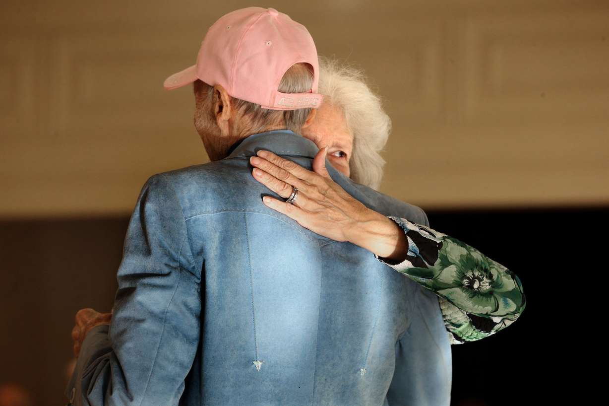 Lou Fisher peeks over her boyfriend's shoulder while dancing at the Tenth East Senior Center in Salt Lake City on Wednesday, Feb. 4, 2015. (Photo: Laura Seitz, Deseret News)