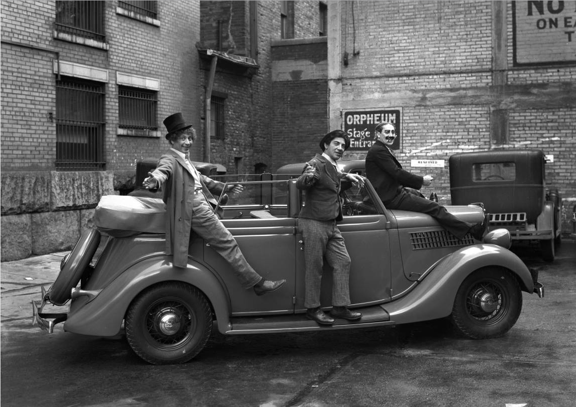 The Marx Brothers take a little time out from their "Night at the Opera" performances for a promotional shoot for a local Ford dealership in April 1935. Behind them is the stage entrance to the Orpheum Theater and the back entrance to the Kearns Building. (Photo: Utah State Historical Society )
