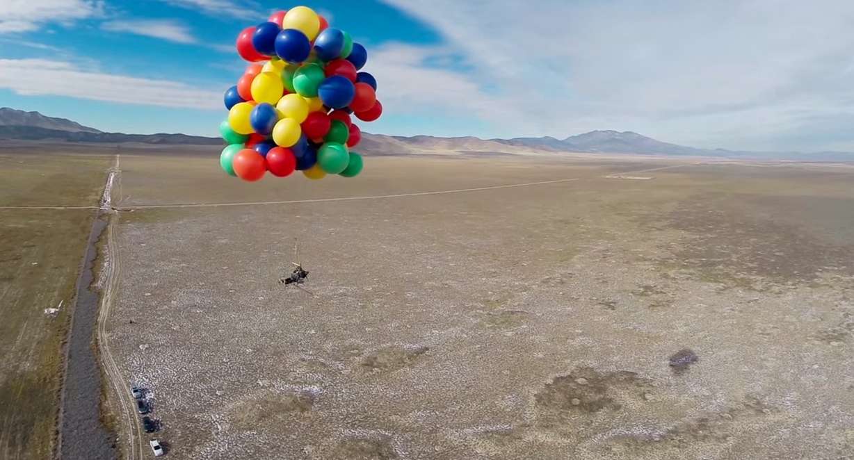 Erik Roner skydiving from balloon-lifted lawn chair. Photo Credit: YouTube Capture