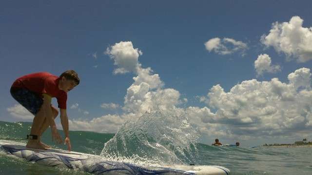 Inspiring an athlete — Hancock also taught John to surf. Here, John glides on his board during a Special Olympics practice at Stuart Beach in July 2011. (Courtesy Rachel Miller)