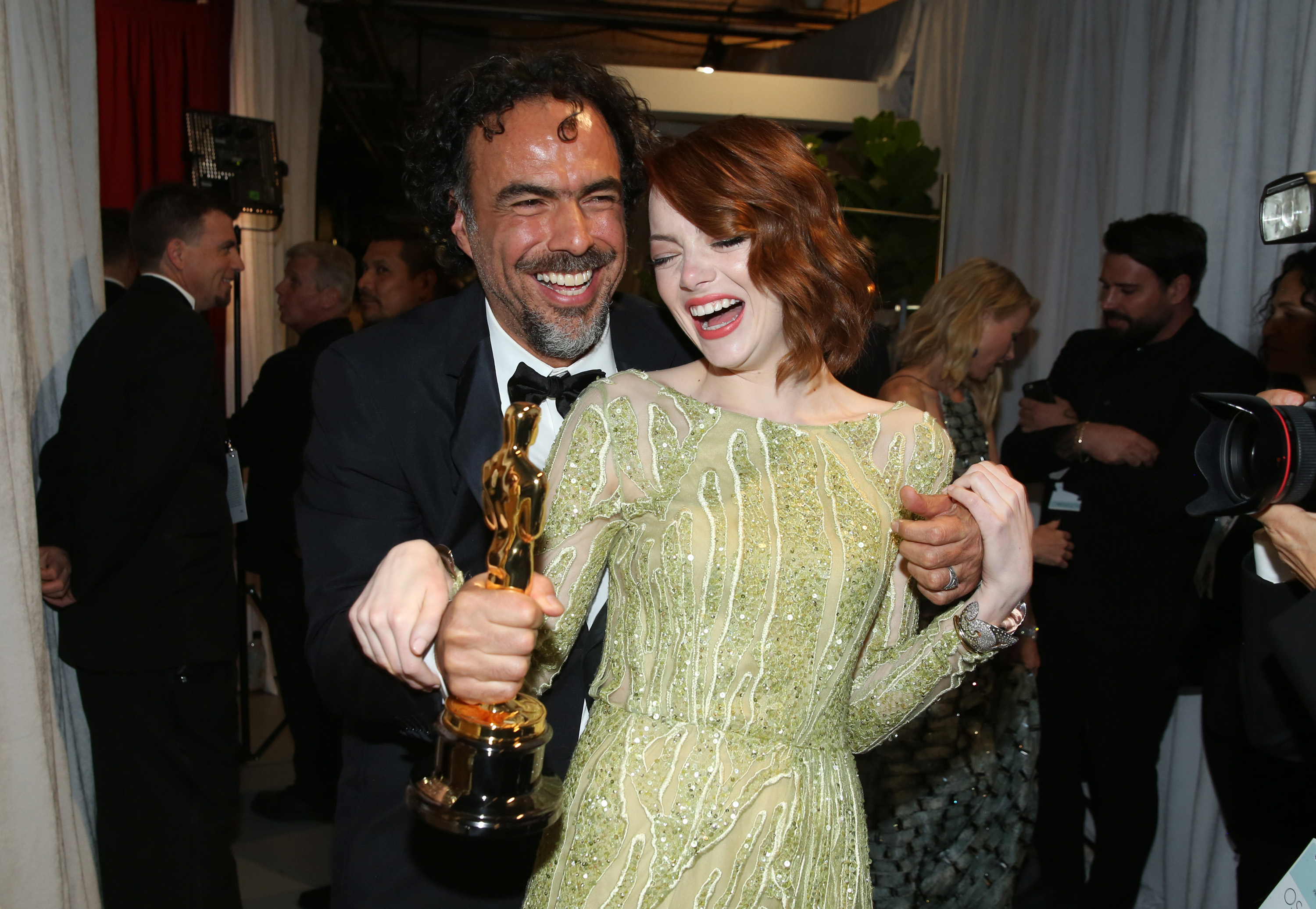 Alejandro Gonzalez Inarritu, left, and Emma Stone are seen backstage at the Oscars on Sunday, Feb. 22, 2015, at the Dolby Theatre in Los Angeles. (Photo by Matt Sayles/Invision/AP)