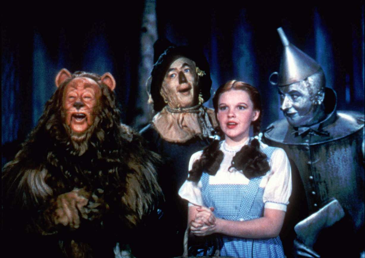 In this 1939 file photo originally released by Warner Bros., from left, Bert Lahr as the Cowardly Lion, Ray Bolger as the Scarecrow, Judy Garland as Dorothy, and Jack Haley as the Tin Woodman, are shown in a scene from "The Wizard of Oz." (AP Photo/Warner Bros., file)