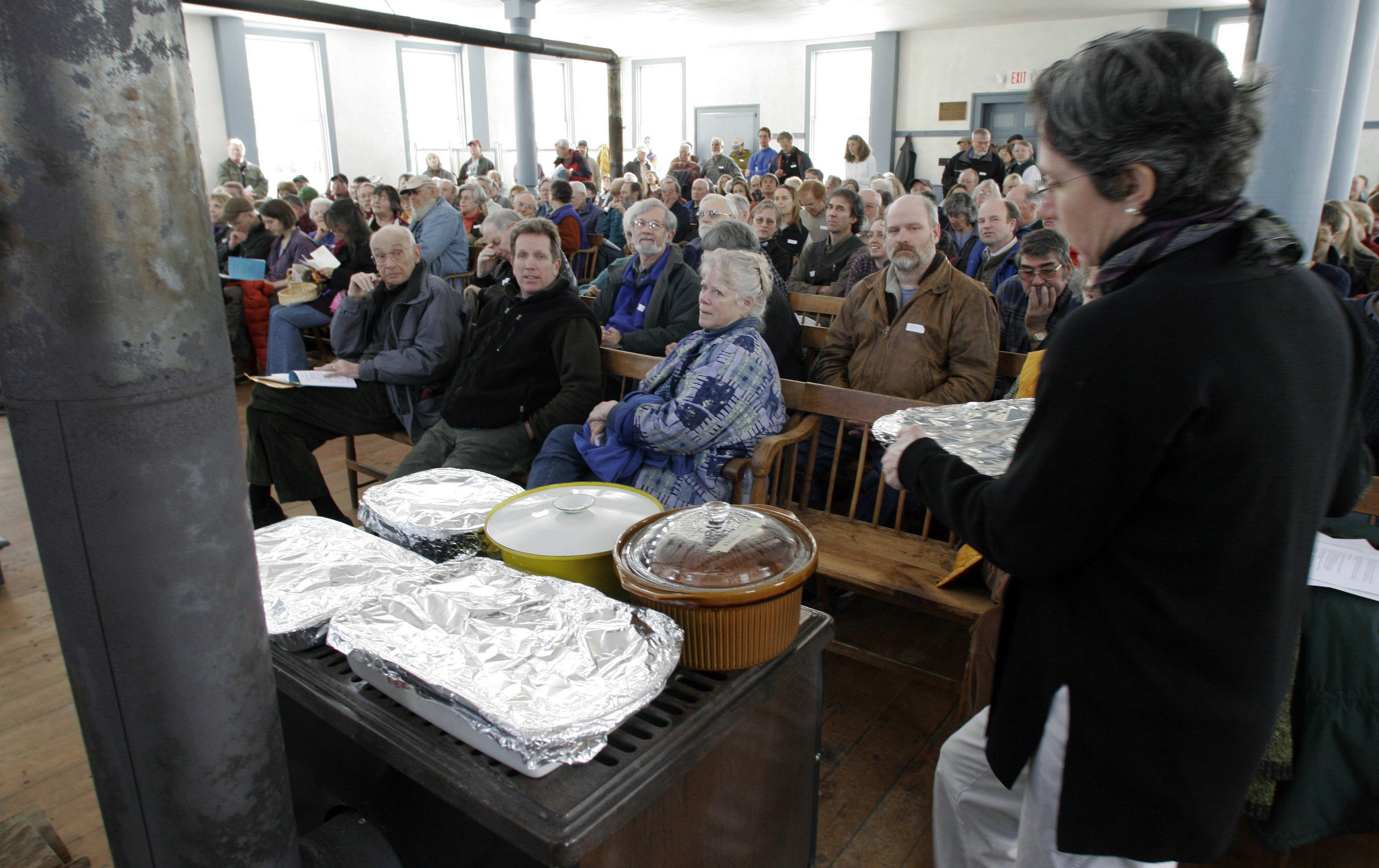 FILE - In this March 7, 2006 file photo, food warms on the wood stove during town meeting in Strafford, Vt. Statistics compiled by the Environmental Protection Agency show that the heavily forested states of Vermont, New Hampshire and Maine are among the top five in the country for the per capita emission of pollutants from wood stoves used to heat homes. Nationally, the EPA is pressing ahead with regulations to significantly limit the pollution from newly manufactured residential wood heaters. But some states with the most wood smoke are refusing to go along. (AP Photo/Toby Talbot, File)