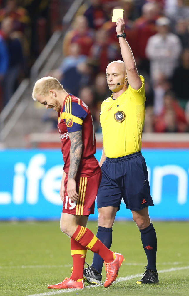 Real Salt Lake midfielder Luke Mulholland receives a yellow card from head official Allen Chapman during RSL's 3-3 draw with the Philadelphia Union on March 14, 2015 in Sandy, Utah. (Jeffrey D. Allred/Deseret News)