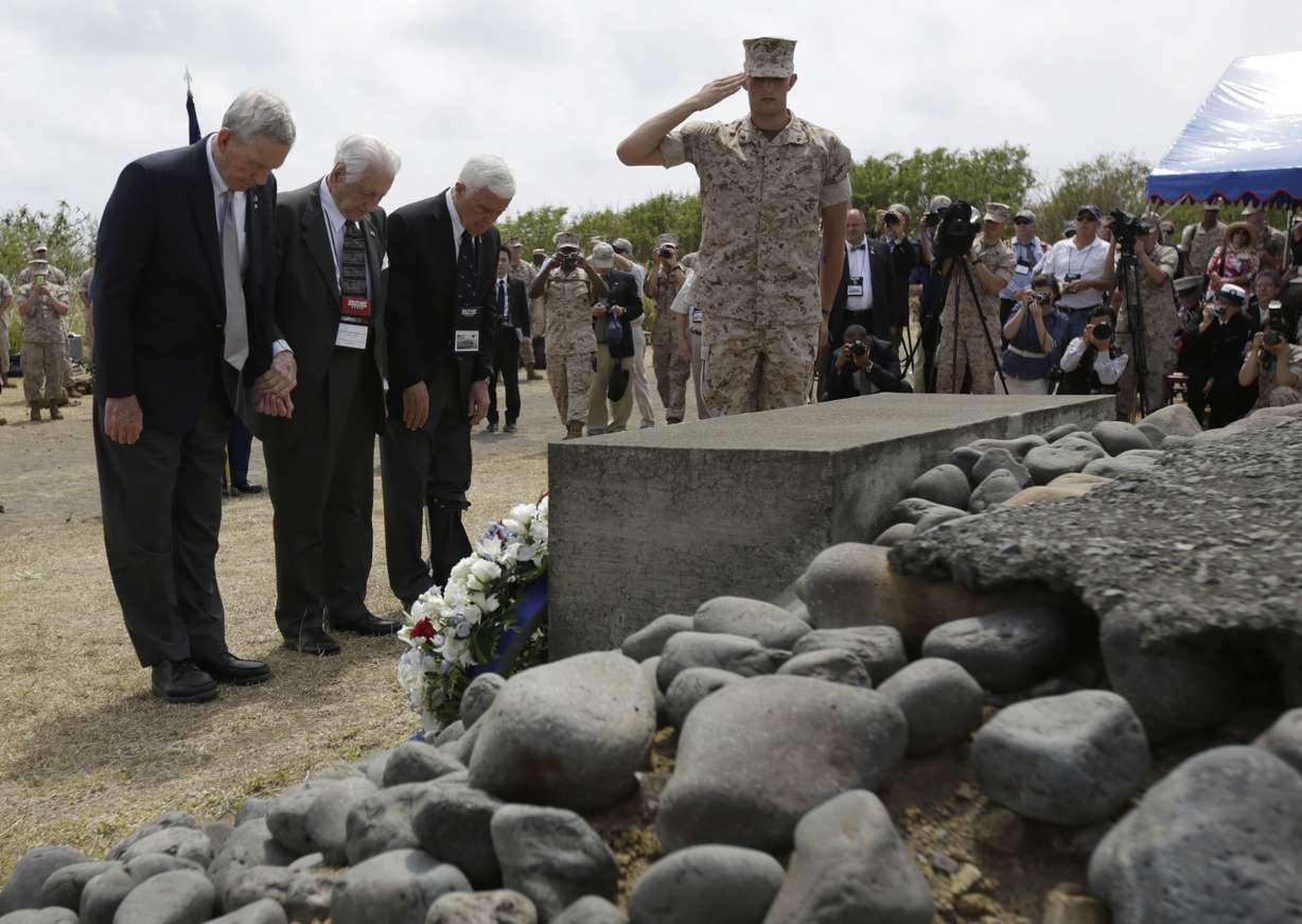 U.S. veterans pay respect at the Iwo Jima battle monument during a ceremony commemorating the 70th anniversary of the Battle of Iwo Jima on Iwo Jima, now known officially as Ioto, Japan Saturday, March 21, 2015. (AP Photo/Eugene Hoshiko)