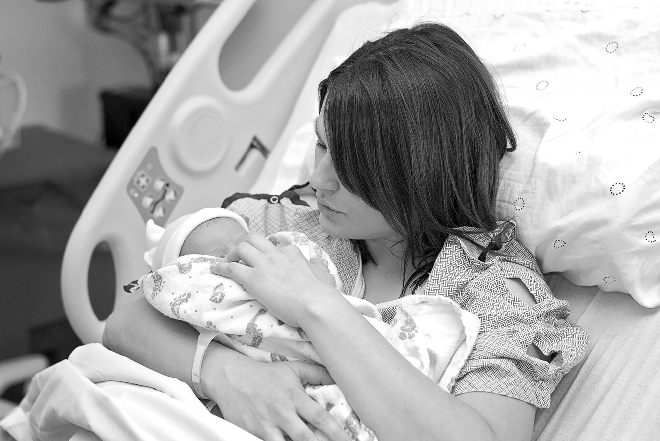 Emily Edmonds holds her baby shortly after giving birth this past September. (Photo: Maegan Graham)