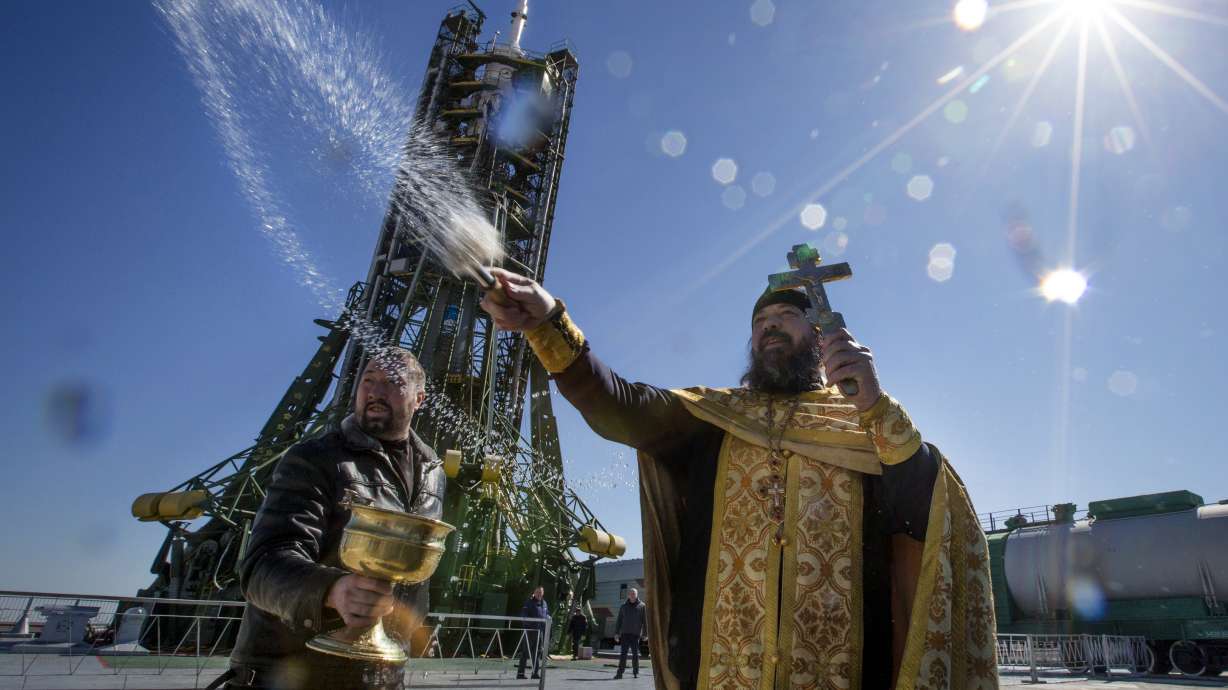 Astronauts board space station for 1-year mission