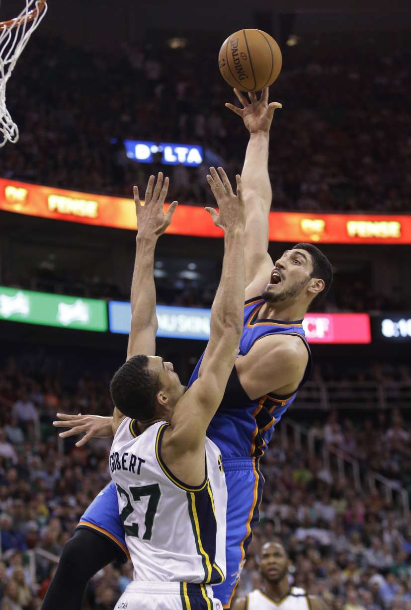Oklahoma City Thunder center Enes Kanter, right, shoots against Utah Jazz center Rudy Gobert (27) during the second quarter of an NBA basketball game Saturday, March 28, 2015. (AP Photo/Rick Bowmer)