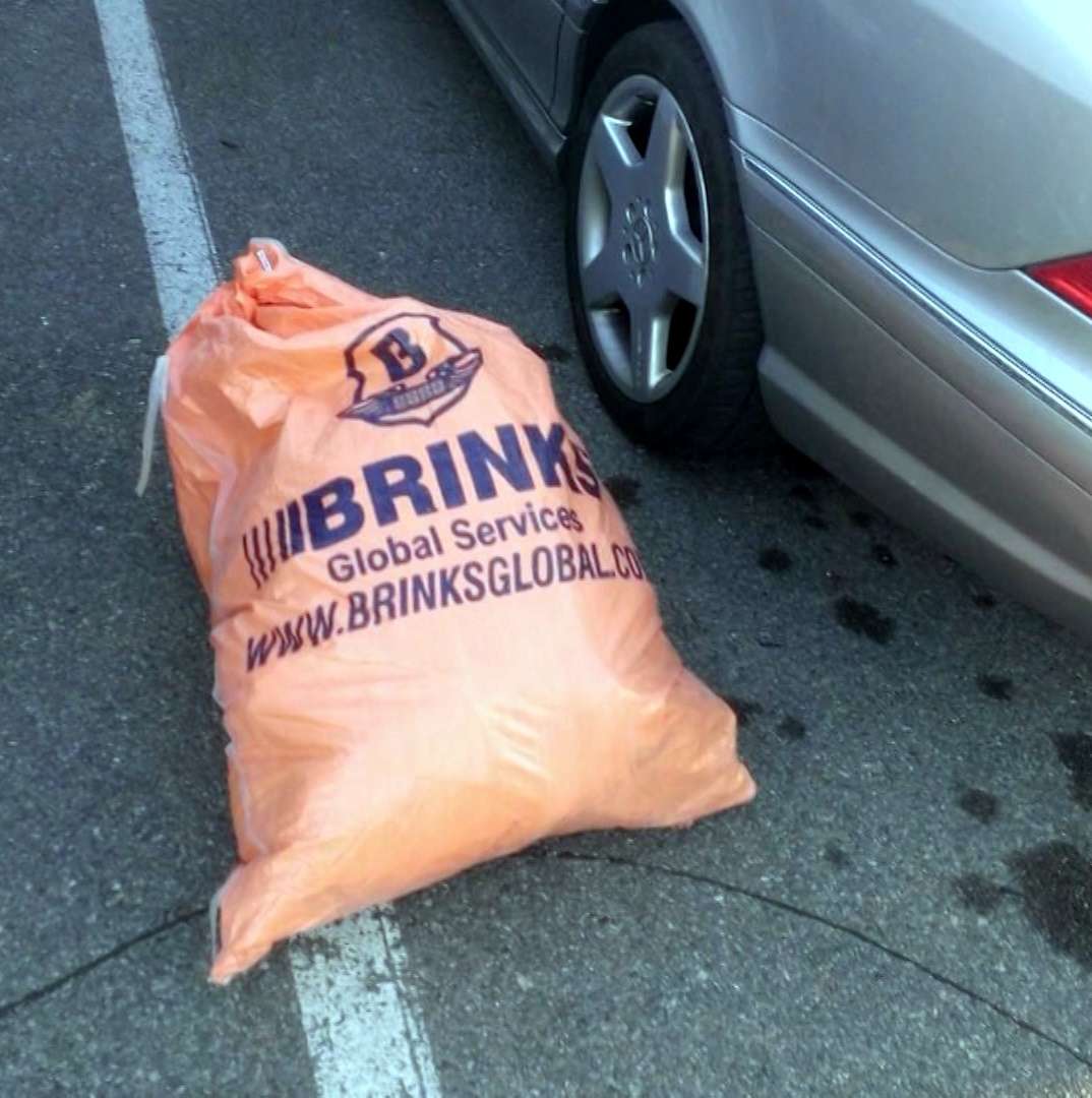Dan Kennedy was driving to work Tuesday, March 31, 2015, when he saw a large orange bag spill onto the roadway from a truck in front of him. He quickly discovered it was an enormous bag of cash belonging to the Brink's cash transportation company and called police to return it. (Photo: Utah Department of Public Safety)