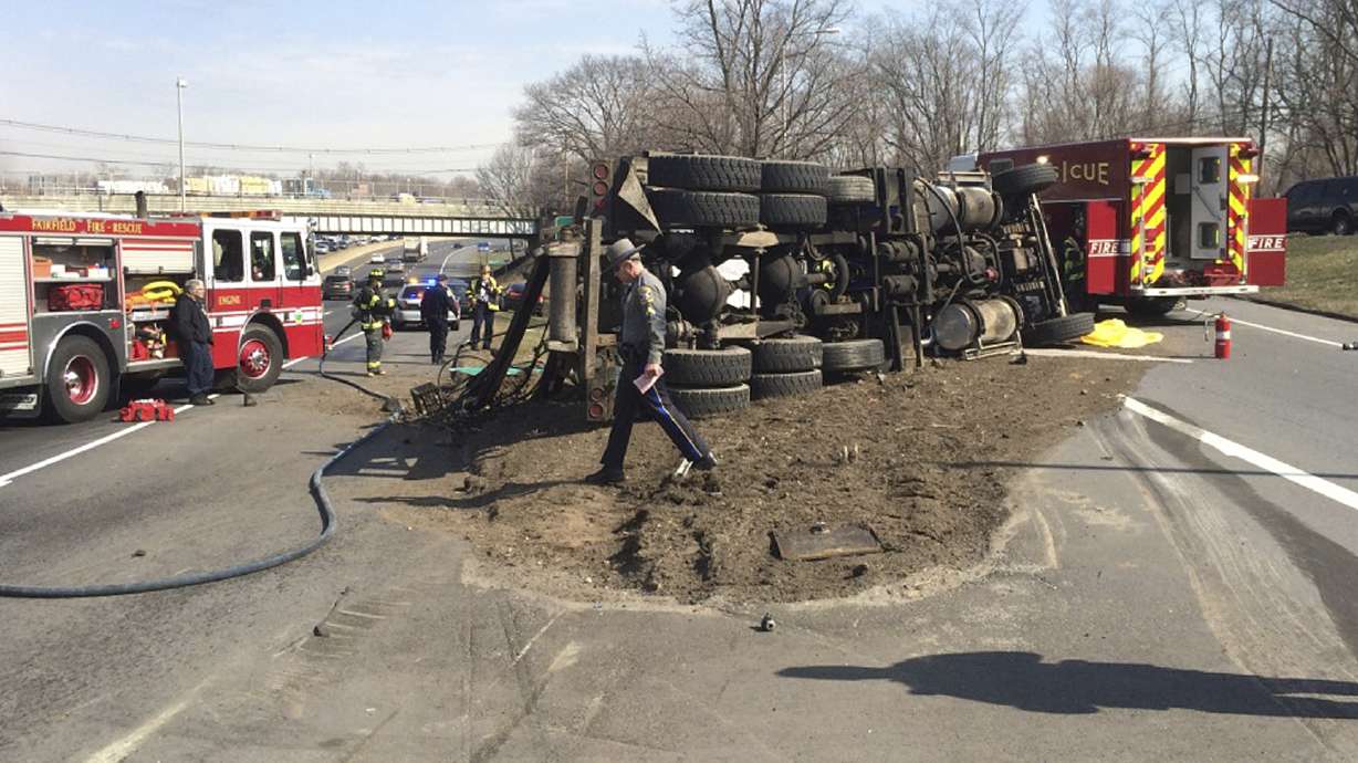 Garbage truck hits highway overpass, flips over; driver dies