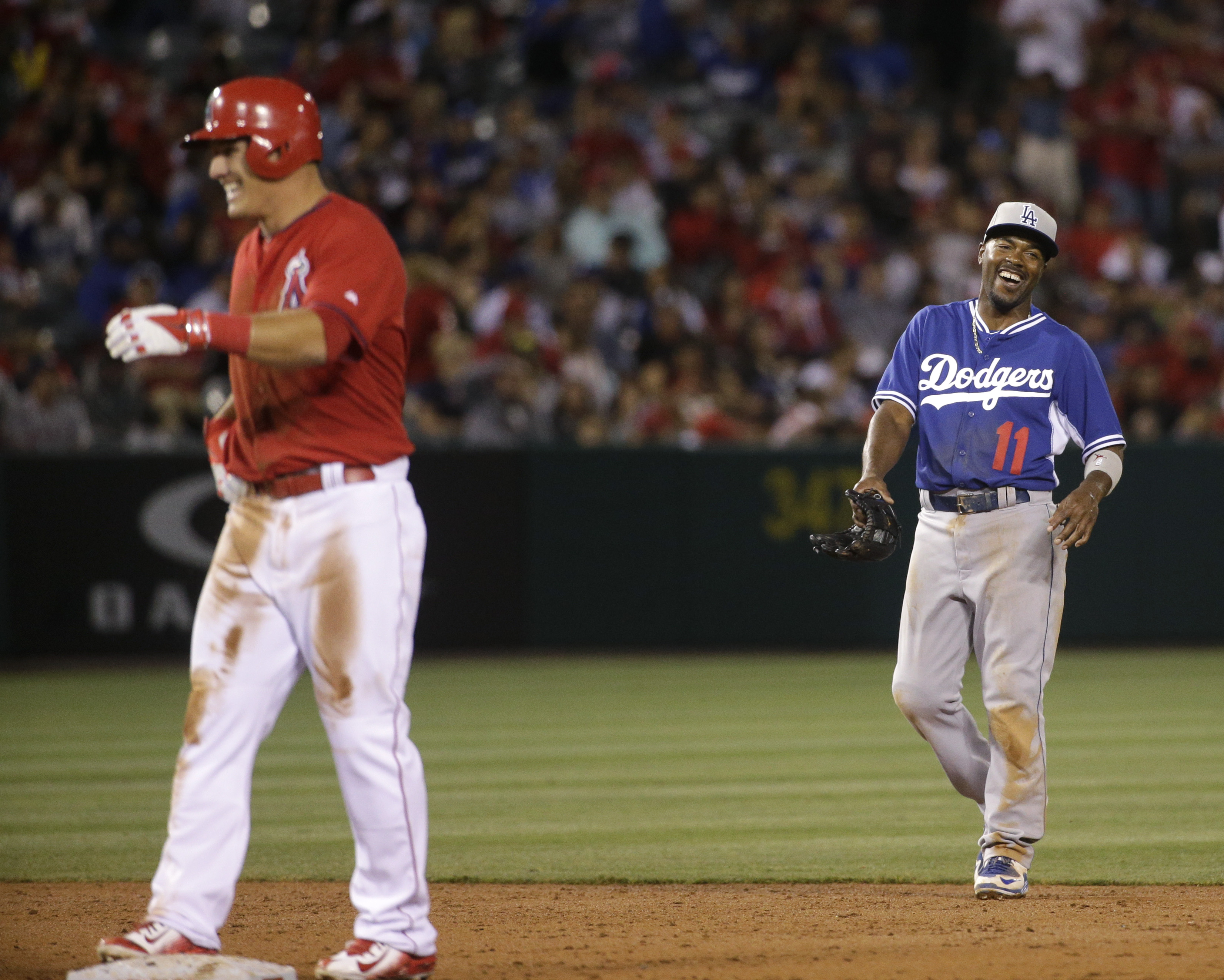 Puig OK after collision; Trout helps Angels beat Dodgers 3-2