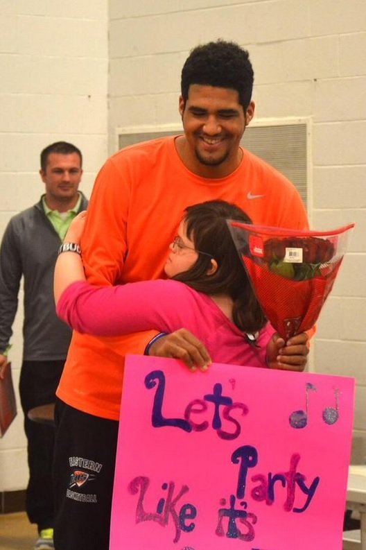 A Division 1 College recruit and a high school freshman, Trey Moses and Ellie Meredith couldn't be more different. Moses, now a Ball State signee at David Letterman's alma matter, had his prom date decided, his girlfriend. But this week, that all changed when Meredith, a highly functioning student with Down syndrome was prom-posed to by Moses. (Emina Kilim/Eastern High School)