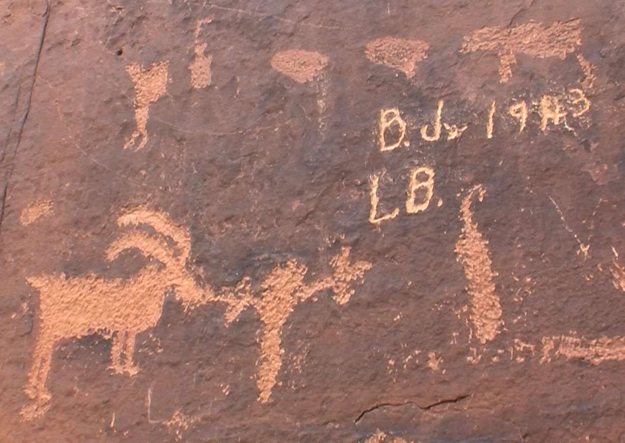 Vandalism on the Rochester Panel, an interpretive site managed by the Bureau of Land Management's Price field office, shows that the problem has been ongoing for decades. (Photo: Geoff Liesik, KSL-TV)