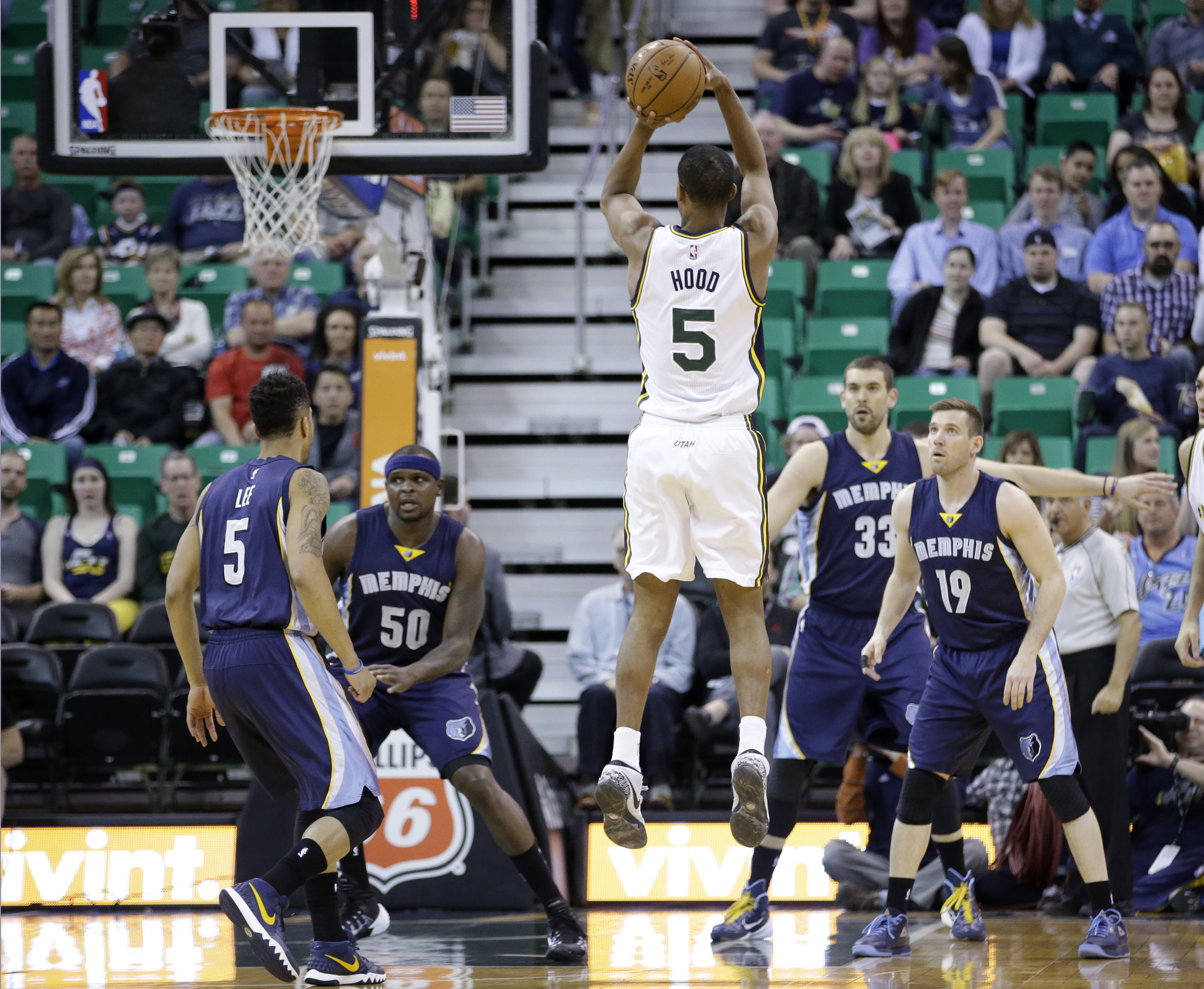 Utah Jazz guard Rodney Hood (5) shoots against Memphis Grizzlies' Courtney Lee (5), Zach Randolph (50), Marc Gasol (33) and Beno Udrih (19) during the first quarter of an NBA basketball game Friday, April 10, 2015, in Salt Lake City. (Rick Bowmer/AP Photo)