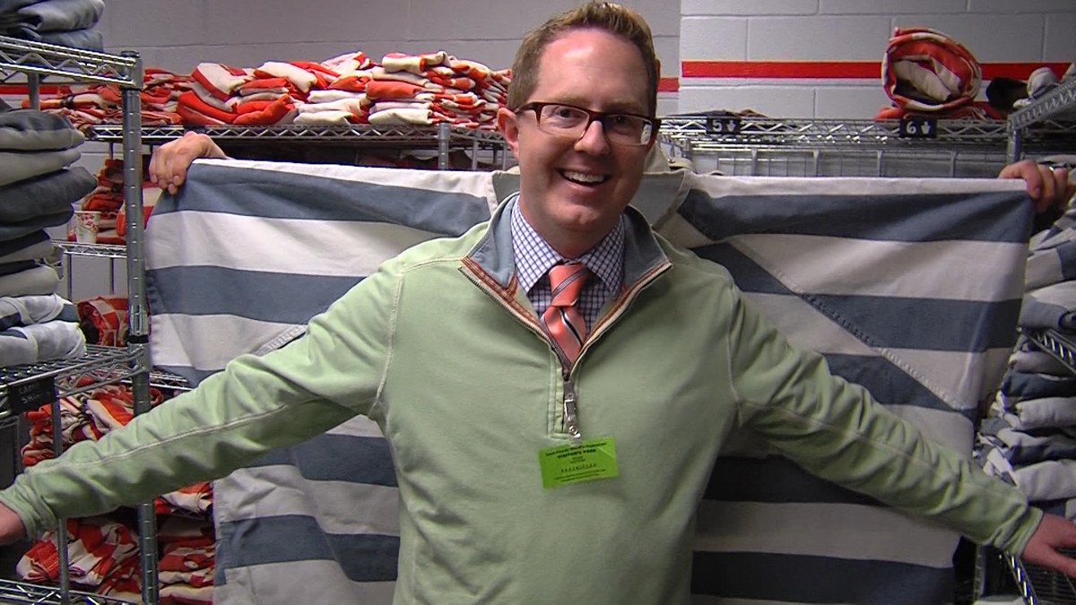 Andrew Adams showing off the size of a men's 10XL uniform at the Davis County Jail. (Photo: Alan Neves/KSL-TV)