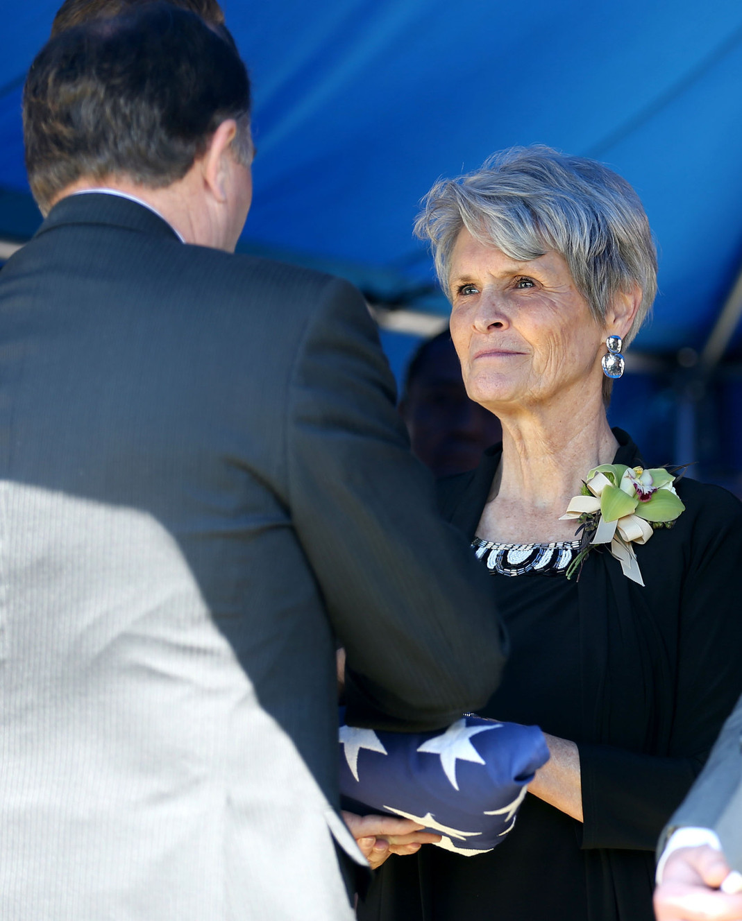 Gov. Gary Herbert delivers the casket flag to Judy Bangerter during the interment for her husband, former Gov. Norman H. Bangerter, at the South Jordan City Cemetery in South Jordan on Saturday, April 18, 2015. (Photo: Kristin Murphy, Deseret News)