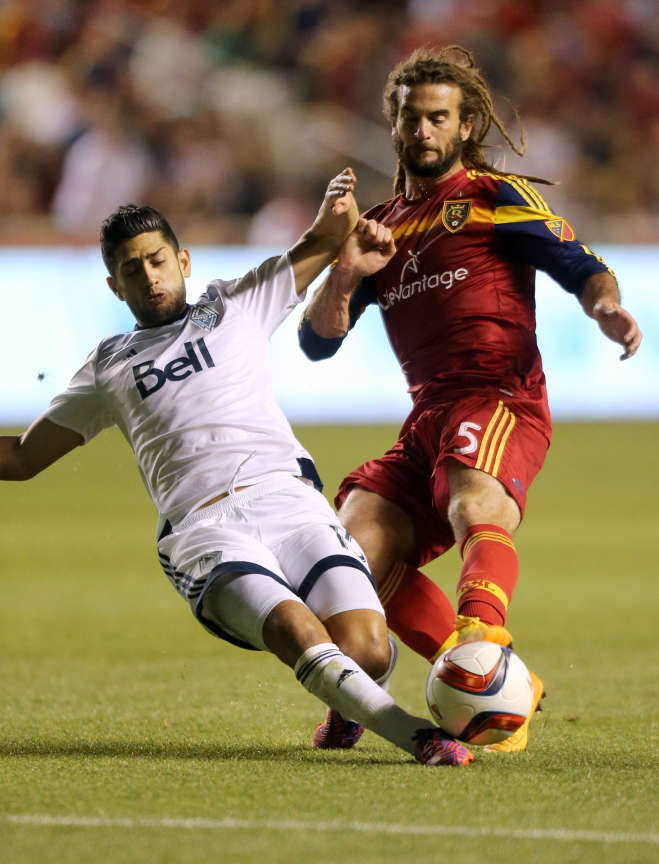 Vancouver Whitecaps' Matias Laba and Real Salt Lake's Kyle Beckerman kick the ball a soccer game at the Rio Tinto Stadium in Sandy on Saturday, April 18, 2015. (Kristin Murphy/Deseret News)