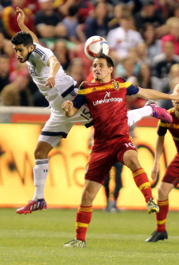 Vancouver Whitecaps' Matias Laba and Real Salt Lake's Luis Gil reach for a header during in a soccer game at the Rio Tinto Stadium in Sandy on Saturday, April 18, 2015. (Kristin Murphy/Deseret News)