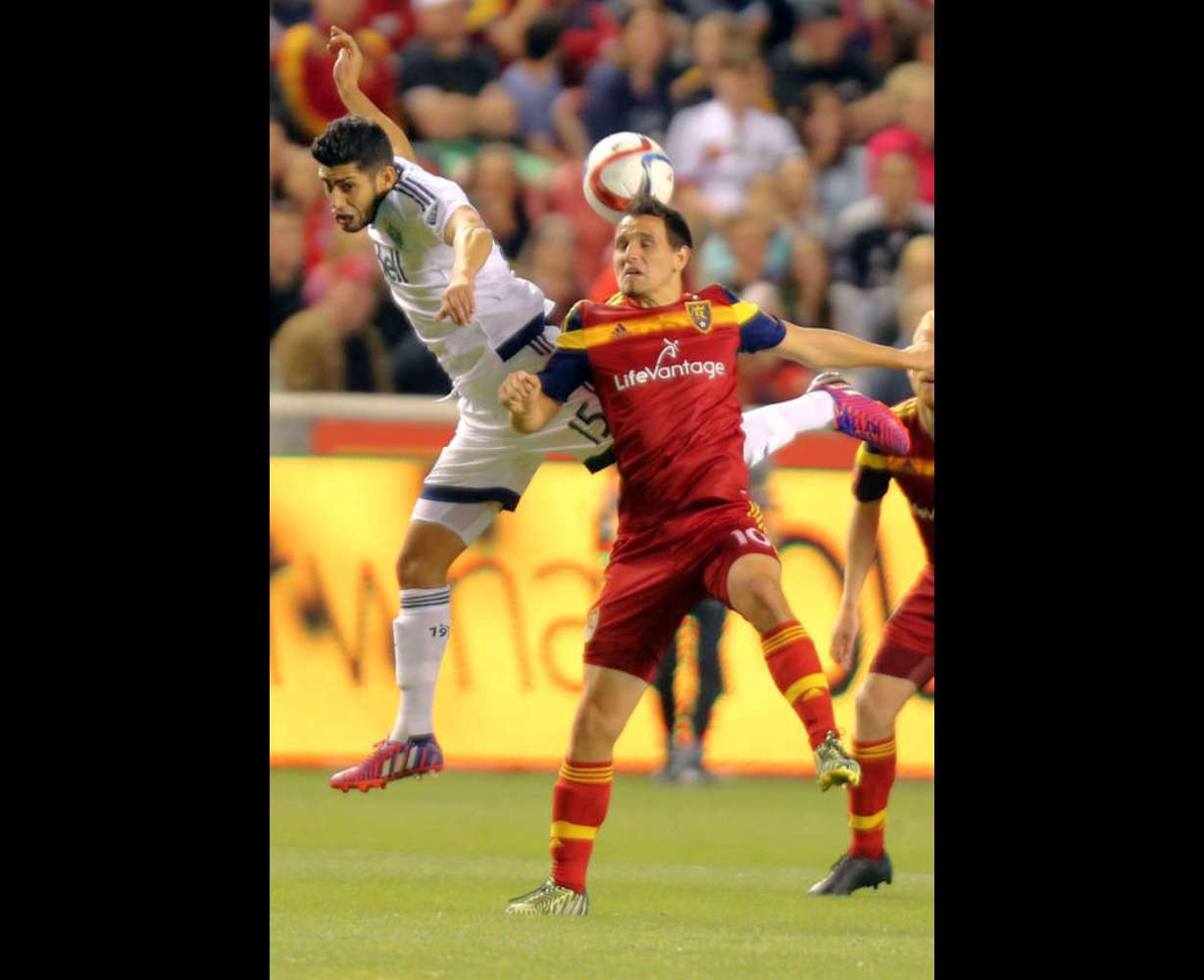 Vancouver Whitecaps' Matias Laba and Real Salt Lake's Luis Gil reach for a header during in a soccer game at the Rio Tinto Stadium in Sandy on Saturday, April 18, 2015. (Kristin Murphy/Deseret News)