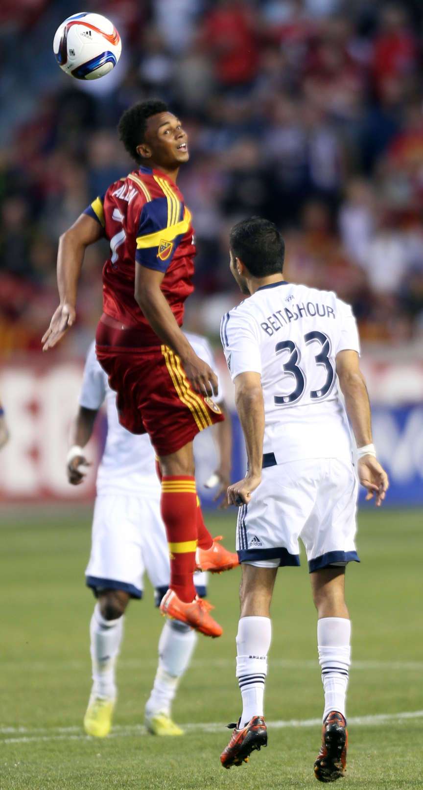 Real Salt Lake's Jordan Allen and the Vancouver Whitecaps' Steven Beitashour reach for a header during a soccer game at the Rio Tinto Stadium in Sandy on Saturday, April 18, 2015. (Kristin Murphy/Deseret News)