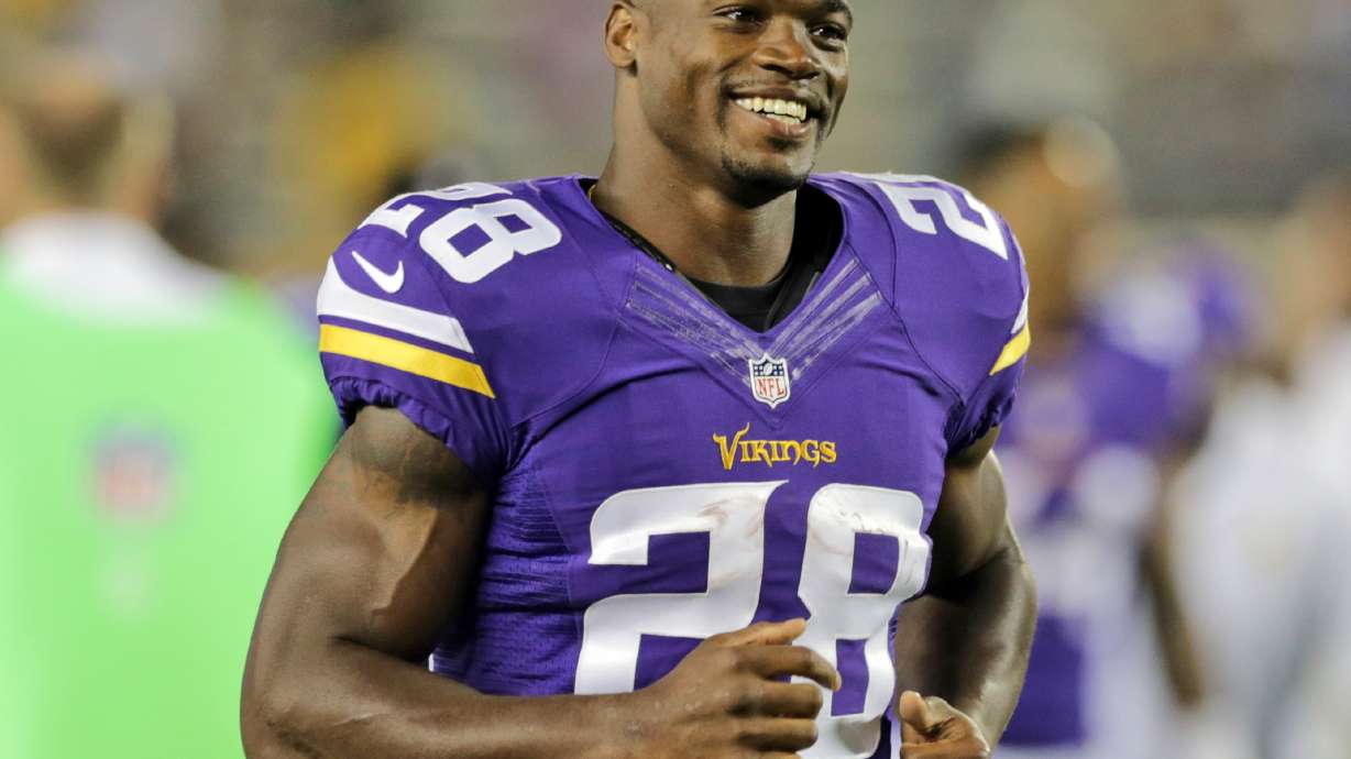 AP source: Peterson stays home from Vikings workouts