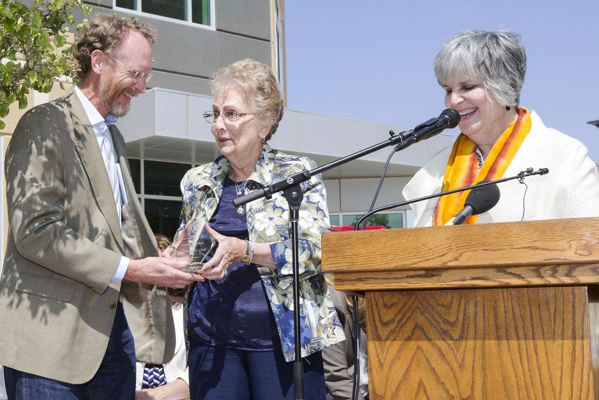 Shaun McGrath regional administrator of the EPA, presents Midvale Mayor JoAnn Seghini an award after announcing that the Midvale slag superfund site was officially removed from the U.S. Superfund list at a ceremony Monday, April 20, 2015, at FLSmidth in Midvale. (Photo: Scott G Winterton, Deseret News)