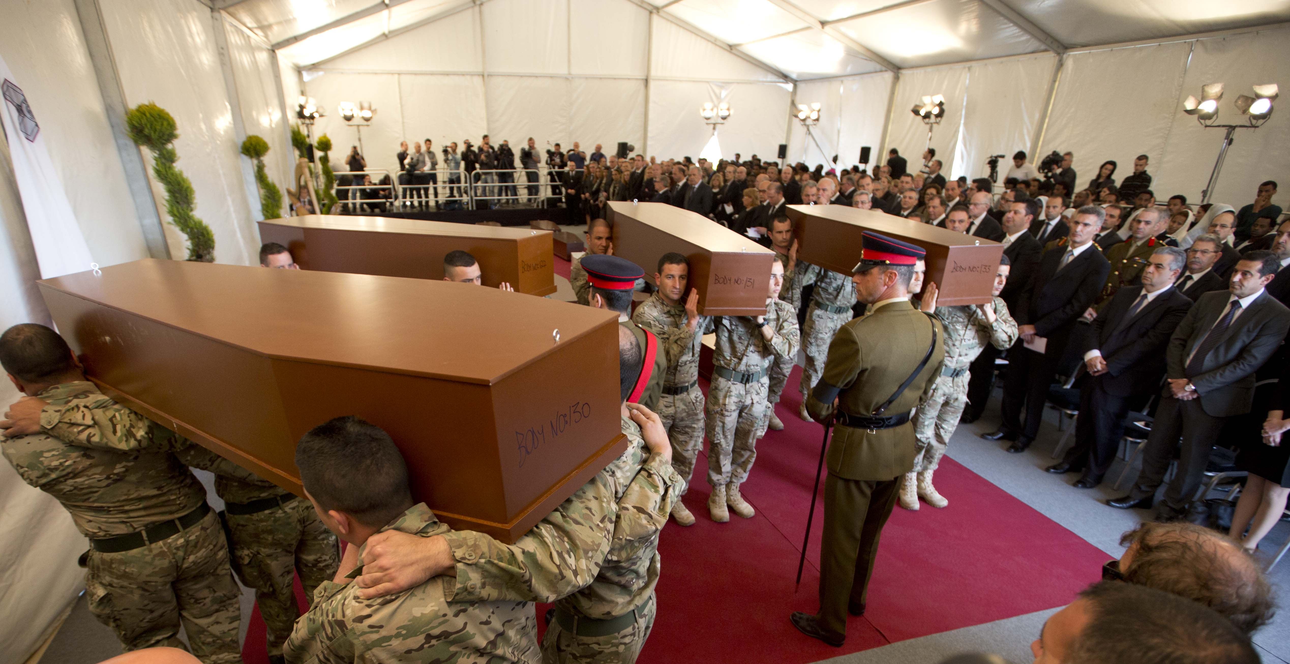 Europe buries migrants as lawyer defends suspected captain