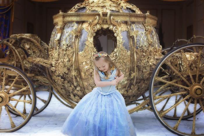 4-year-old Giselle Bewley poses in front of the Golden Carriage at Disney World. (Photo: Courtesy Kristina Bewley/Giselle Evelyn Photography)