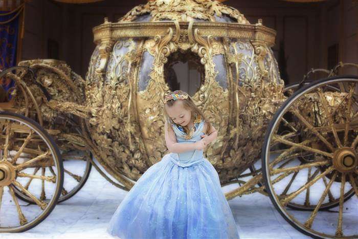 4-year-old Giselle Bewley poses in front of the Golden Carriage at Disney World. (Photo: Courtesy Kristina Bewley/Giselle Evelyn Photography)