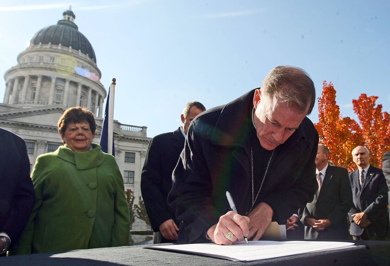 Bishop John C. Wester signs a document known as the Utah Compact during a press conference where community leaders gathered in support of immigration reform at the state Capitol in Salt Lake City Thursday, Nov. 11, 2010. (Photo: Brian Nicholson, Deseret News archives)