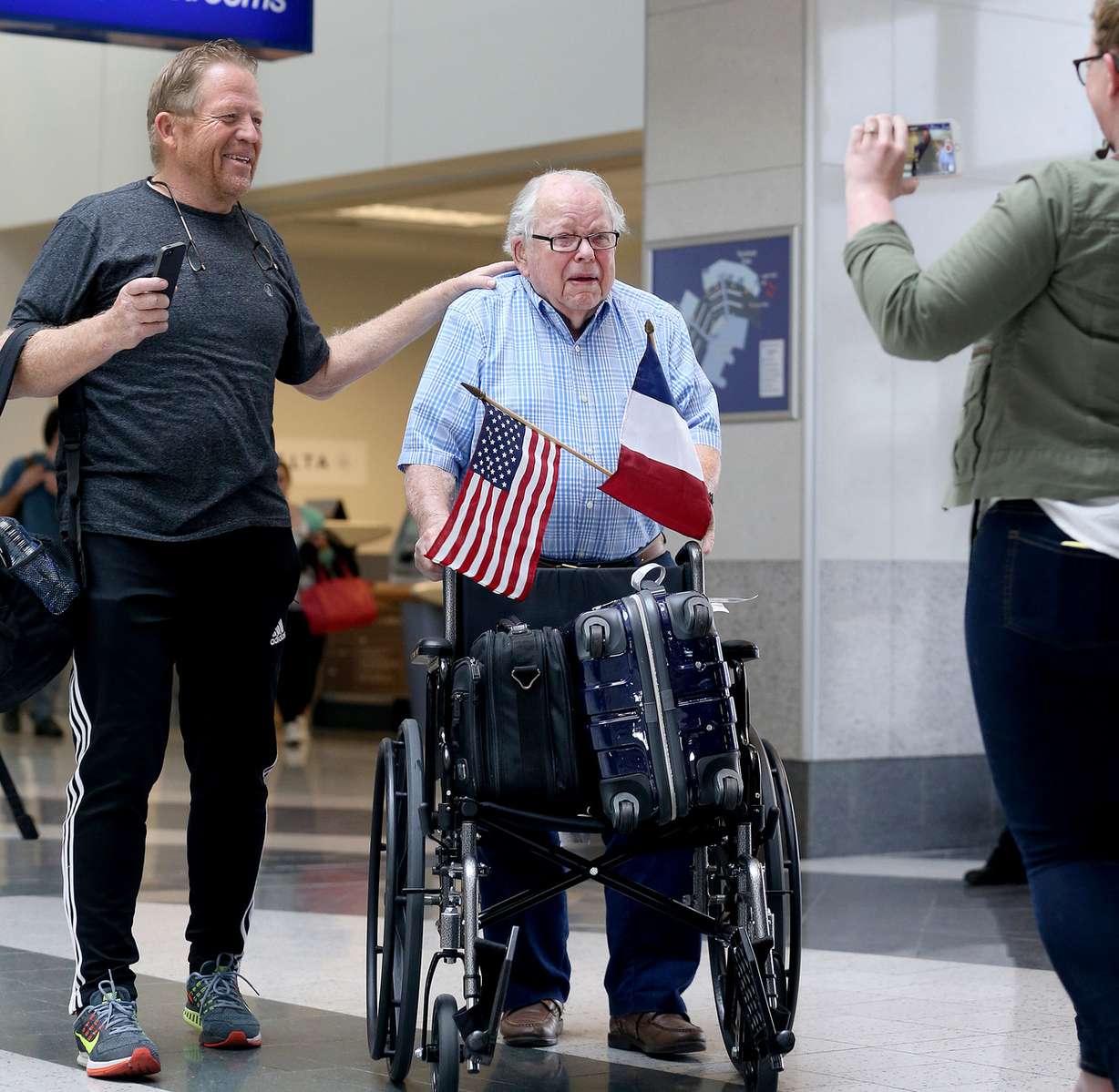 World War II veteran Bob Ord and his son Dan Ord, left, are greeted by family after a 10-day trip retracing his steps in France at Salt Lake City International Airport on Wednesday, May 6, 2015. Ord fought all through France during WWII until liberation. (Photo: Laura Seitz, Deseret News)