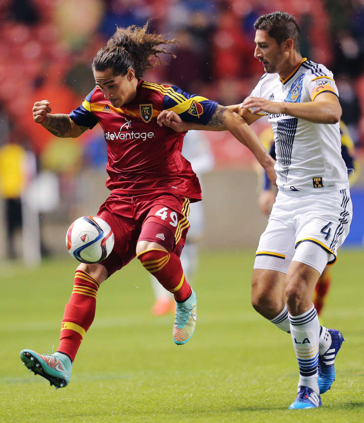 Real Salt Lake forward Devon Sandoval (49) works to get ahead of Los Angeles Galaxy defender Omar Gonzalez (4) with the ball as RSL and the LA Galaxy play Wednesday, May 6, 2015, at Rio Tinto Stadium in Sandy. (Scott G Winterton/Deseret News)