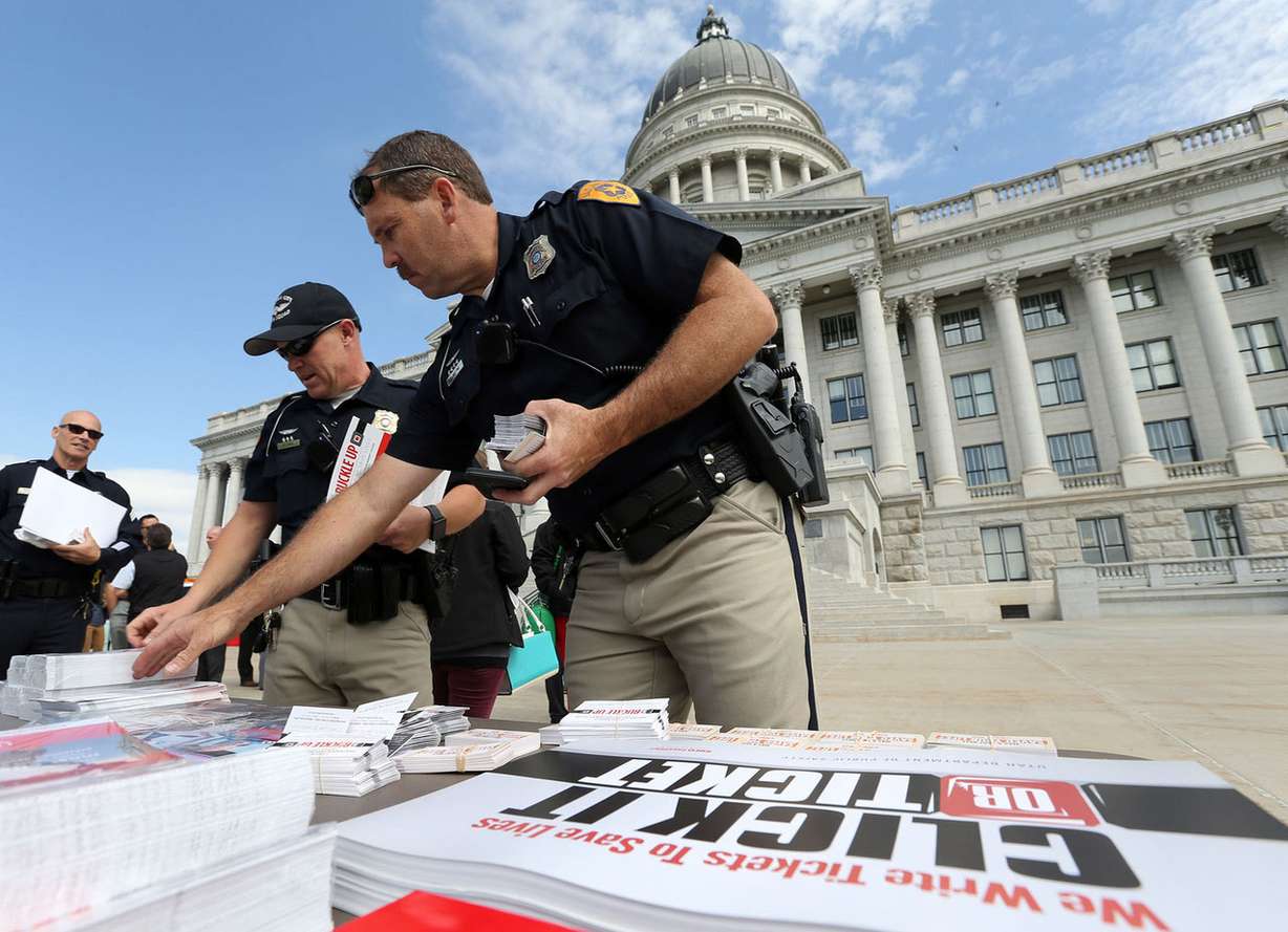 Salt Lake City police officers Robert Smith and Shane Whiting pick up informational packets and cards that they can later hand out at the kickoff celebration for Utah's new seat belt law, Thursday, May 7, 2015. The law goes into effect May 12. Photo: Kristin Murphy, Deseret News