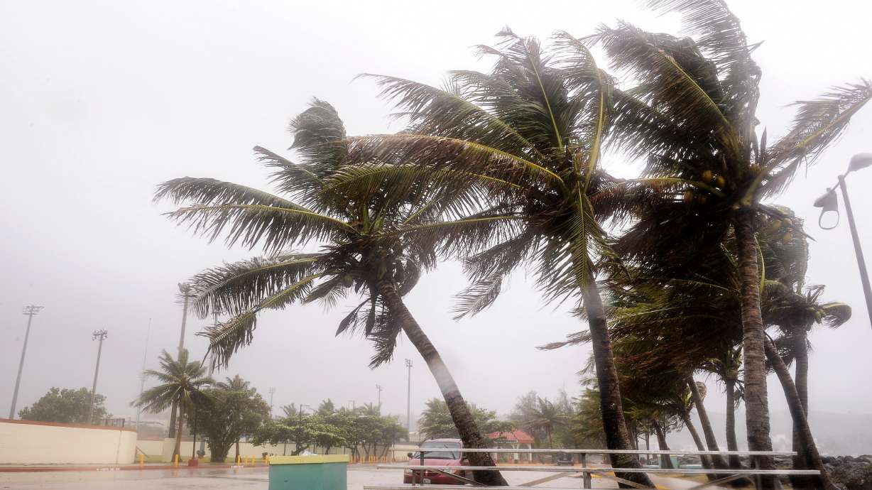 Residents clean up after typhoon pelts Guam with winds, rain