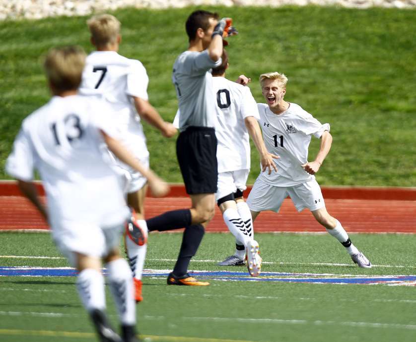Alta forward Bryson Colemere (11) is congratulated by his teammates after scoring the wining goal in overtime at the Class 5A boys soccer semifinals against Lehi at Woods Cross High School in Woods Cross, Tuesday, May 19, 2015. (Chris Samuels/Deseret News)