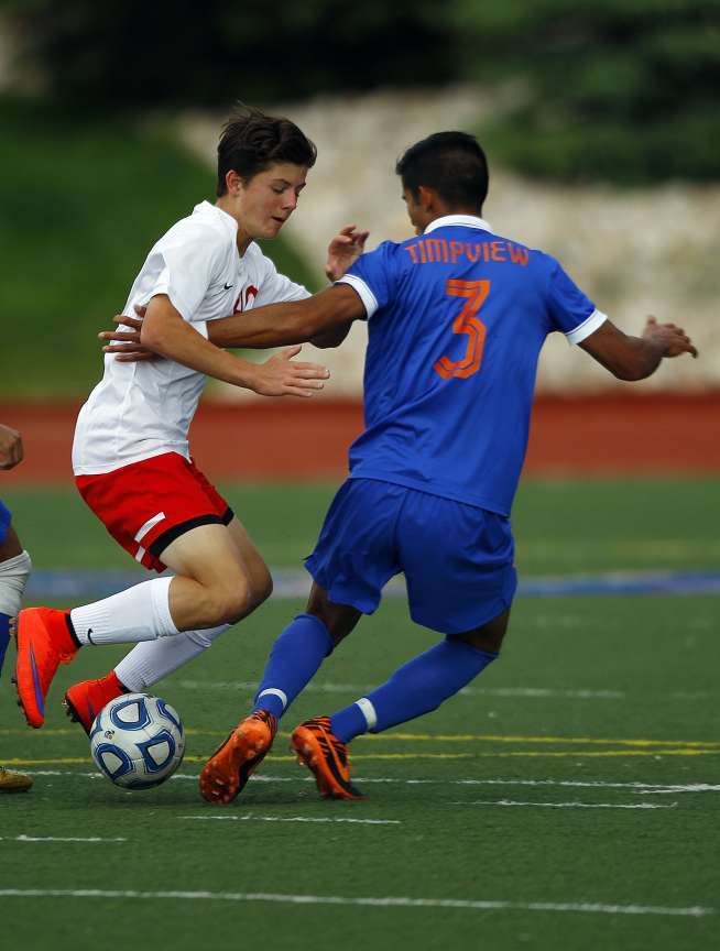 East forward Matthew Barker, left, tries to dribble past Timpview's Jordy Espinoza (3) at the 4A boys soccer semifinals at Woods Cross High School in Woods Cross, Tuesday, May 19, 2015. (Chris Samuels/Deseret News)