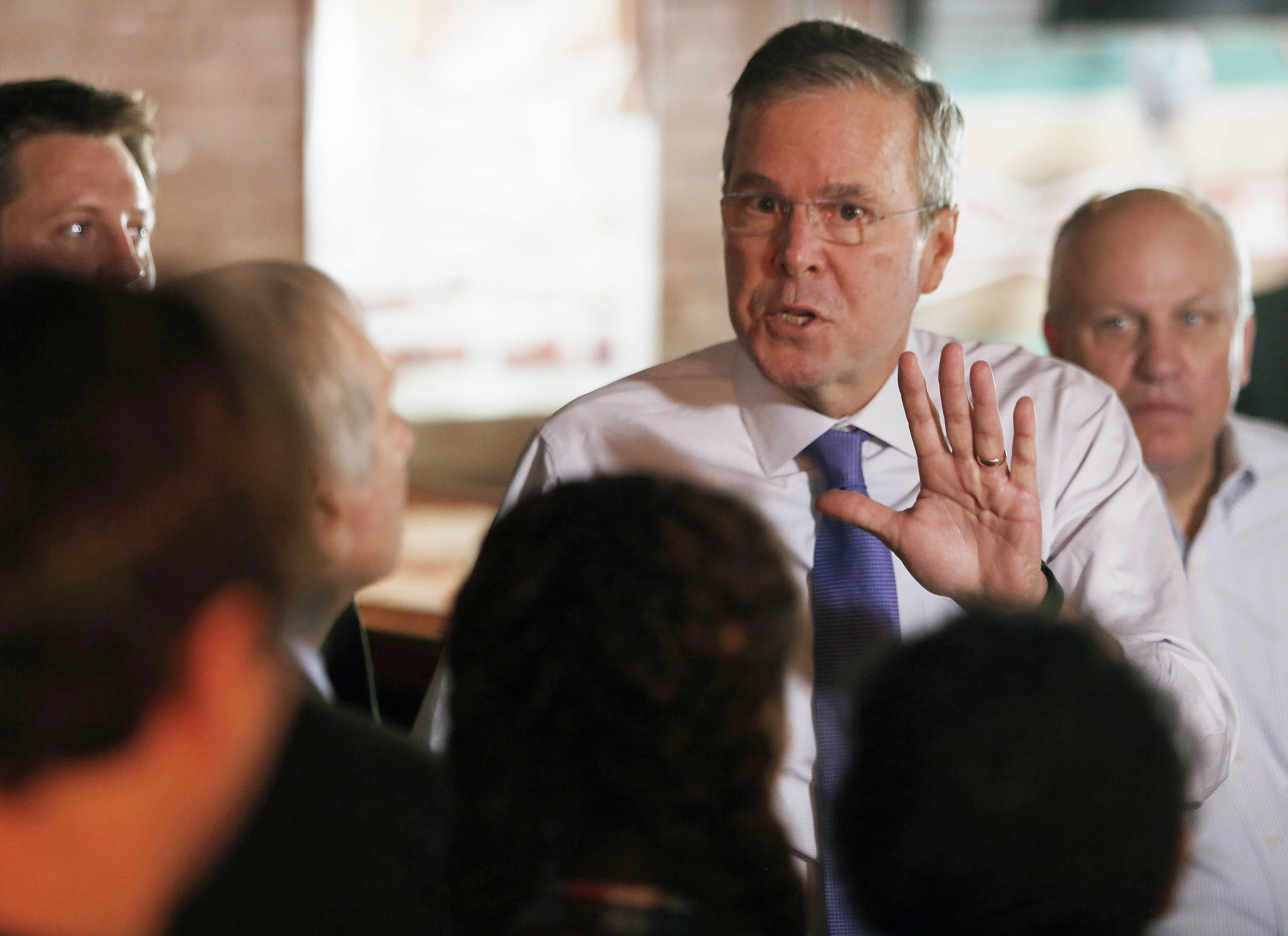 Jeb Bush shifts style, critiques brother's budget management