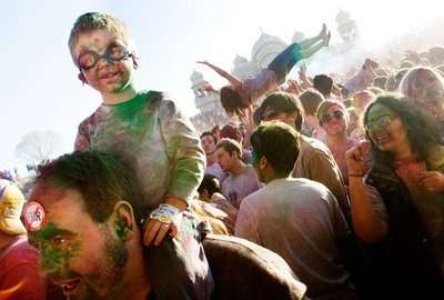 Little boy sits on his dad's shoulders amid a crowd of thousands at the Holi Festival of Colors. (Photo: Courtesy of Festival of Colors)