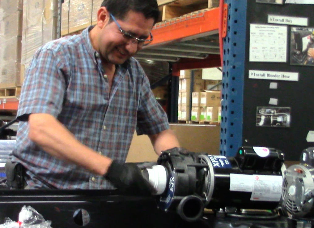 The staff works in teams. This team member is seen installing a motor into the spa. (Photo: Jen Jacobson)