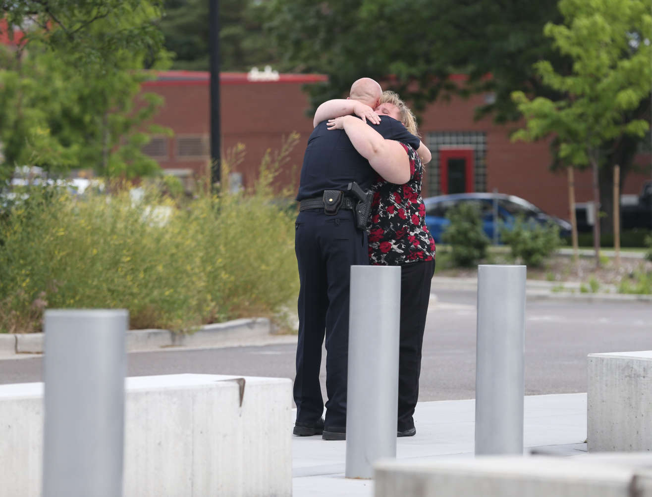 Former Salt Lake City Police Chief Chris Burbank receives a hug from an employee after speaking to the media about his resignation at the Public Safety Building in Salt Lake City on Thursday, June 11, 2015. (Laura Seitz/Deseret News)