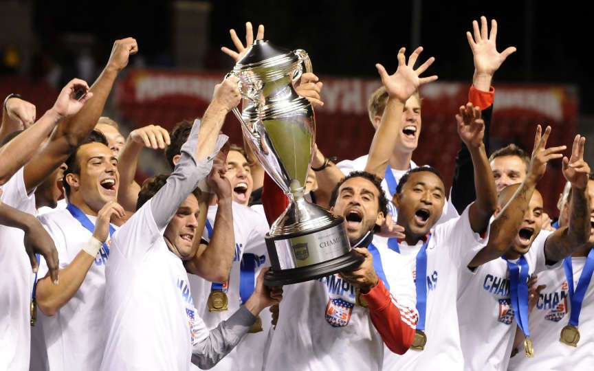 D.C. United coach Ben Olsen and Dwayne De Rosario hoist the Lamar Hunt trophy as the team celebrates after defeating Real Salt Lake 1-0 in the 2013 U.S. Open Cup at Rio Tinto Stadium on October 1, 2013. (Matt Gade/Deseret News)