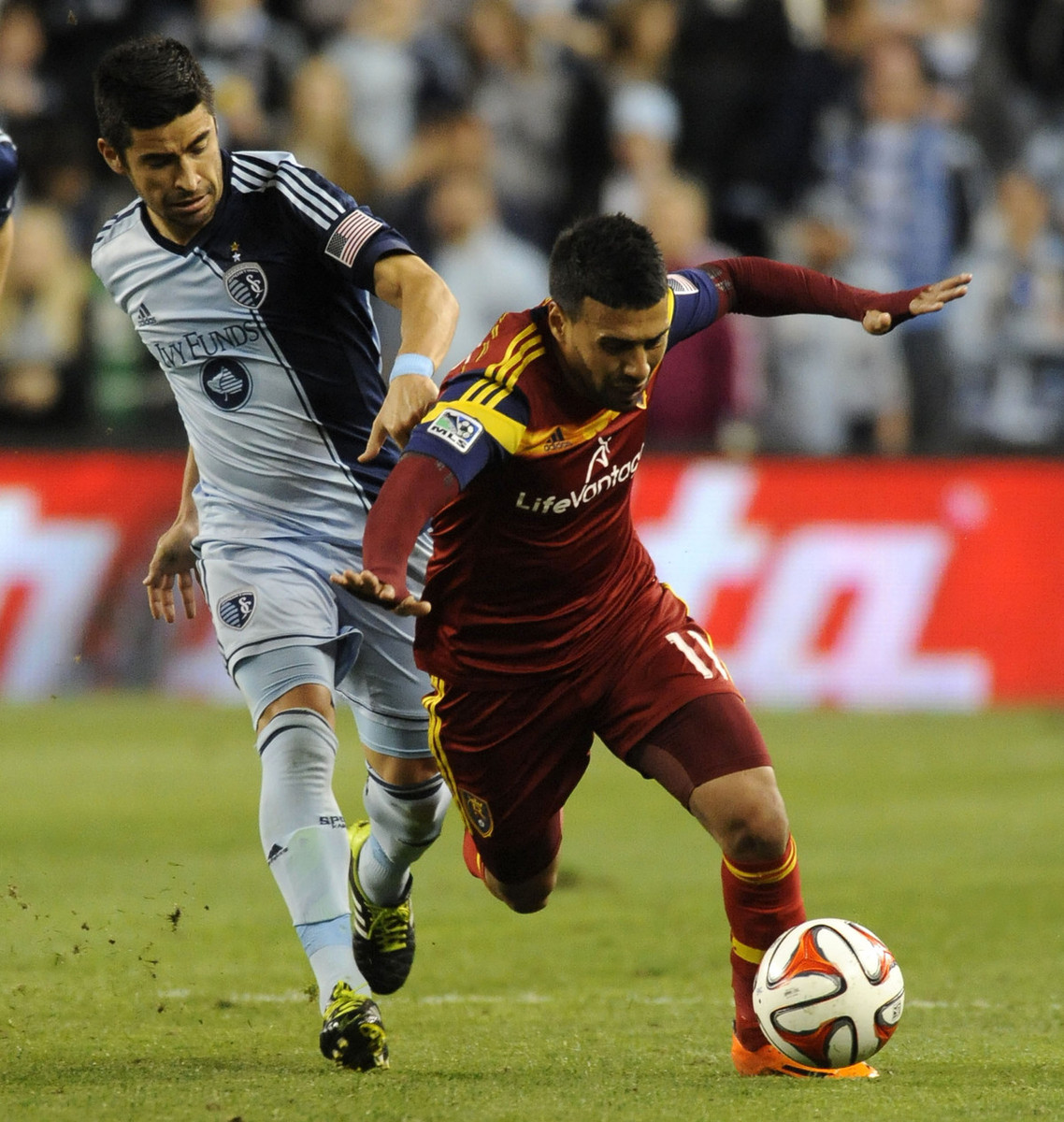 Real Salt Lake's Javier Morales is tripped up by Sporting KC's Paulo Nagamura during a game at Sporting Park in Kansas City, Kan. on Saturday, April 5, 2014. (Photo: Matt Gade/Deseret News)