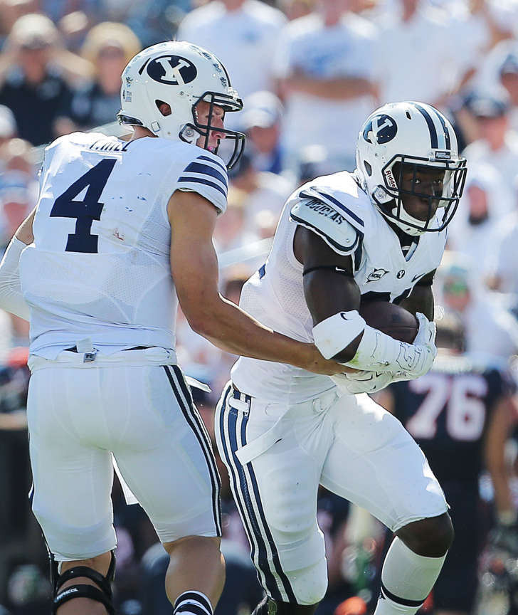 BYU quarterback Taysom Hill (4) hands the ball off to running back Jamaal Williams (21) as BYU and Virginia play Sept. 20, 2014, at LaVell Edwards Stadium in Provo. (Photo: Scott G Winterton/Deseret News)