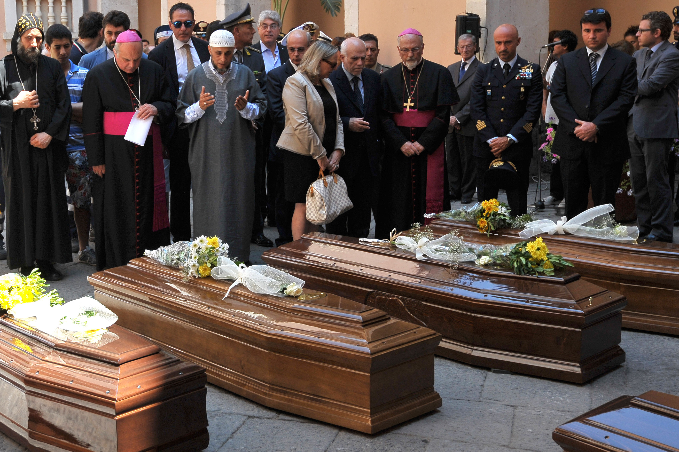 13 coffins: Italy buries 1st bodies from migrant shipwreck