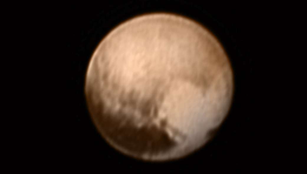 This image received on July 8, 2015 and made available by NASA/Johns Hopkins University Applied Physics Laboratory/Southwest Research Institute shows Pluto from the New Horizons’ Long Range Reconnaissance Imager (LORRI) combined with lower-resolution color information from the spacecraft's Ralph instrument. (NASA/JHUAPL/SWRI via AP)