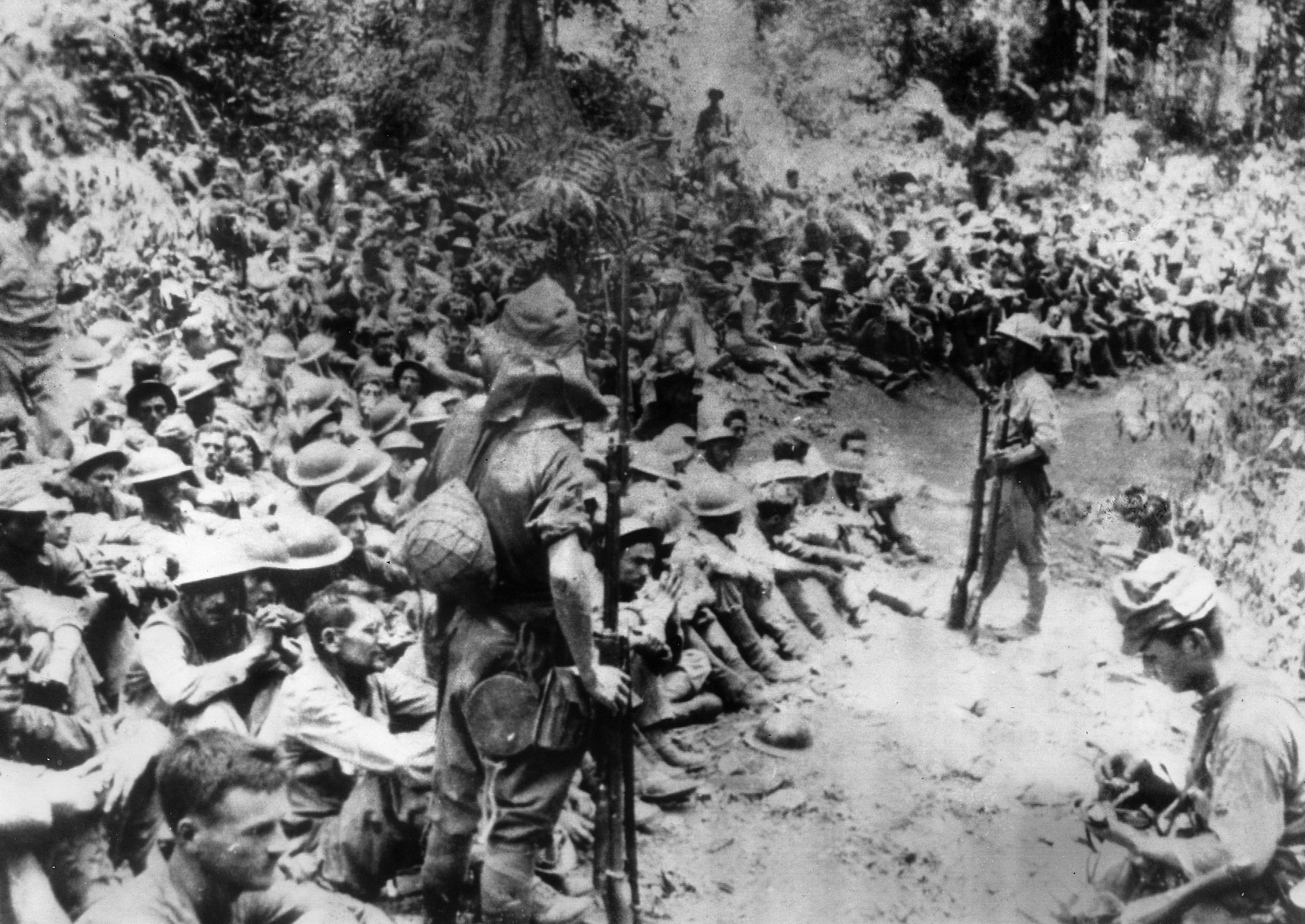 Japanese soldiers stand guard over American war prisoners just before the start of the "March of Death" for the soldiers of Bataan and Corregidor in 1942. This photograph was stolen from the Japanese by the Philippines during Japan's three-year occupation in World War II.
