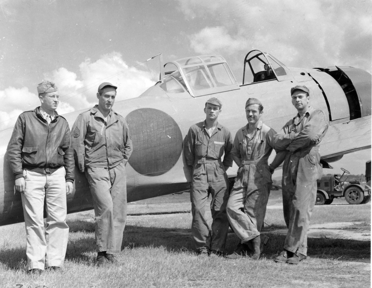 Clyde D. Gessel (on left in officer's uniform) with his American crew standing in front of the first reconstructed flyable Japanese Zero, assembled from five shot-up planes recovered in New Guinea. (Photo: Courtesy of the Grow family)